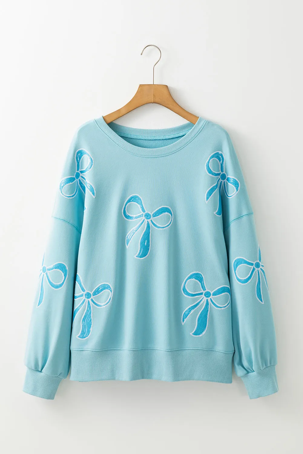 Beau Blue - Sweat-shirt surdimensionné à paillettes et nud papillon à épaules tombantes